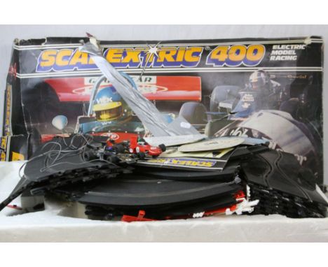 Boxed Scalextric 400 Electric Model Racing Set, with slot cars and two additional cars, box very distressed. Sold with a Nikk