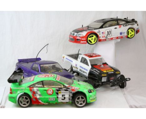 Four fuel remote control cars to include a HPI Racing Chevy Silverado Pick Up truck, a Panda / Thunder Tiger Pick Up Race Tru