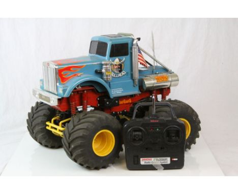 A original vintage 1990 Tamiya Bullhead Dual Motor, eight shock 4WD remote control truck together with remote control.