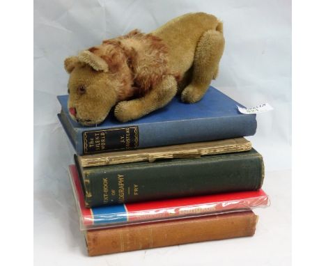 An early Steiff lion with pin in ear (well worn), a selection of books, wood cut pictures, china etc