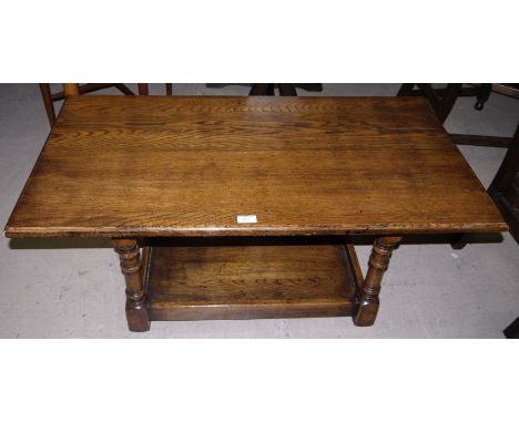 A golden oak coffee table with shelf under in the style of Titchmarsh & Goodwin