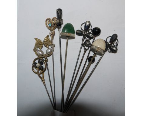 Three Edwardian gilt gem set hat pins and others