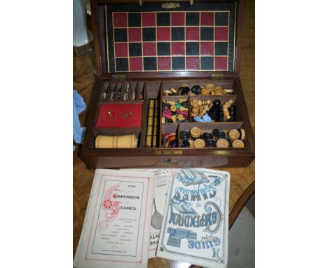 A mahogany cased early 20th century compendium of games including chess, checkers etc