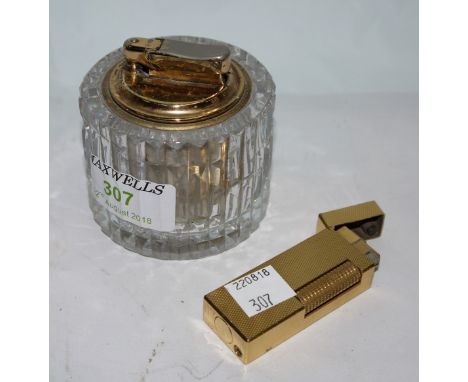 A ladies Dunhill cigarette lighter in engine turned gold plate; a Calibri and Waterford crystal table lighter