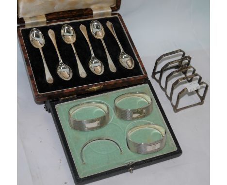 A cased set of 6 silver coffee spoons, Sheffield 1948; a cased set of 3 engine turned napkin rings, Birmingham 1947 (incomple