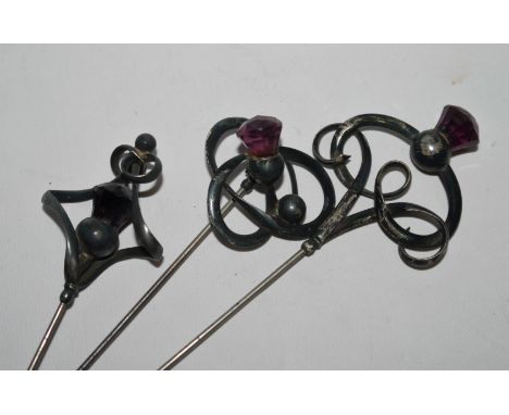 Three hallmarked silver hat pins set with amethysts, by Charles Horner