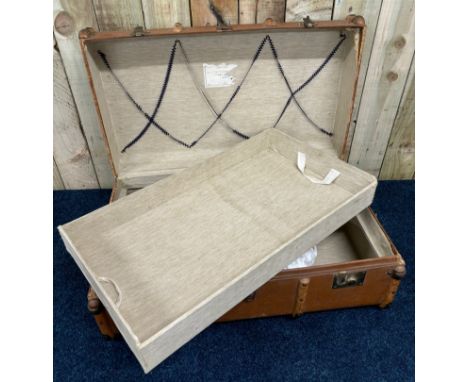 Vintage wooden bound travel trunk. Has original interior drawer present.