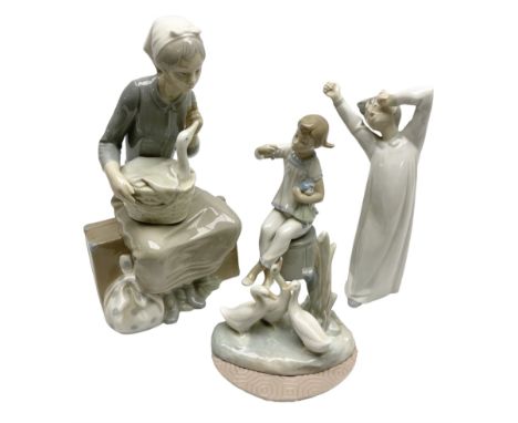 Lladro figures, Girl with Doll, no 1083, together with two Nao figures, and another similar