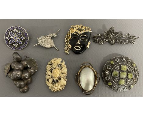 Eight brooches including mother of pearl, 1980's mask brooch, 19th century bone, silver ballerina &amp; bunch of grapes, and 