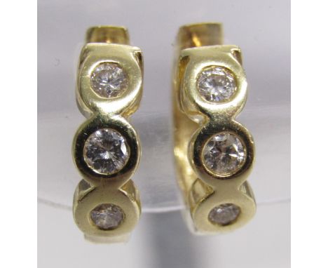 14ct gold hinged hoop rub over 3 stone diamond earrings 0.2ct per earring - total weight 4.9g - marked 585