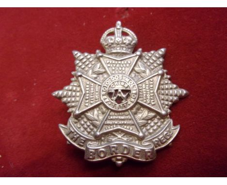 The Border Regiment WWI Forage Cap Badge (White-metal with red cloth backing), two lugs, this variant is slightly larger. K&a