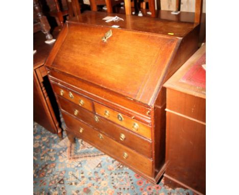 A 19th Century oak bureau fitted slide, two short and two long drawers with plain brass ring handles, on bracket supports, 31