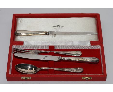 Two specimen coin sets in red cases, a pair of silver enamel cufflinks, in green box, a silver handled letter opener, plated 