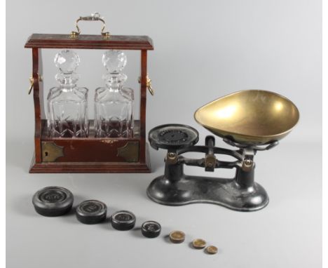 A set of scales with brass pans, a set of weights and a modern two-bottle tantalus