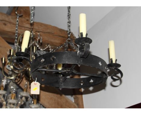 A pair of black wrought iron circular four-light candle holders pierced quatrefoils, 24" wide