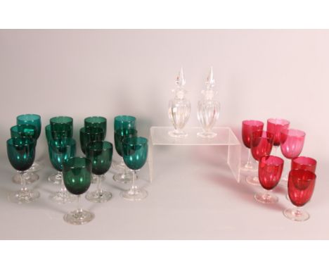 A collection of twenty wine glasses with ruby and green bowls and a pair of hexagonal glass scent bottles with spire stoppers