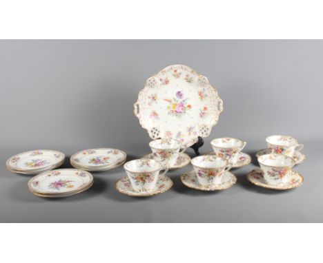 A Dresden floral decorated part teaset comprising six cups, saucers, side plates and a comport