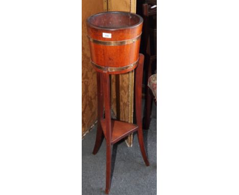 An Edwardian mahogany planter on splay supports fitted undertier, 10" dia