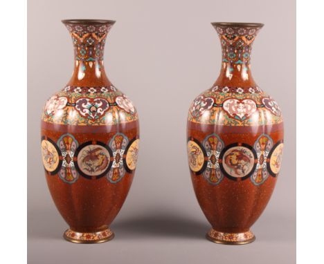 A pair of 19th Century cloisonne oviform vases of lobed outline decorated panels of dragons on a sparkling rust red ground, 1