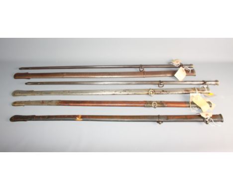 A 19th Century leather and brass mounted sabre scabbard, three 19th Century metal scabbards and two similar (damages)