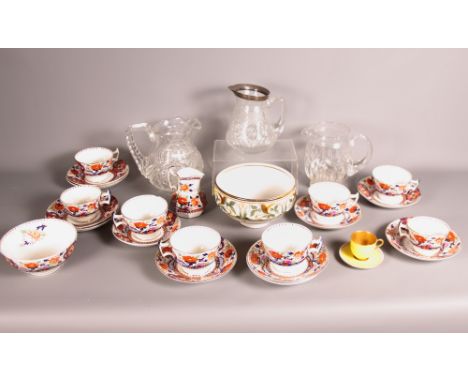 A Royal Worcester yellow cabinet cup and saucer, an Imari pattern teaset, three cut glass jugs, one with silver lip and a stu