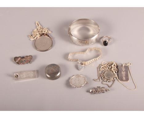 An engraved silver bangle, two silver ingots on chains, a Victorian silver coin brooch, a Mizpah brooch and other silver jewe