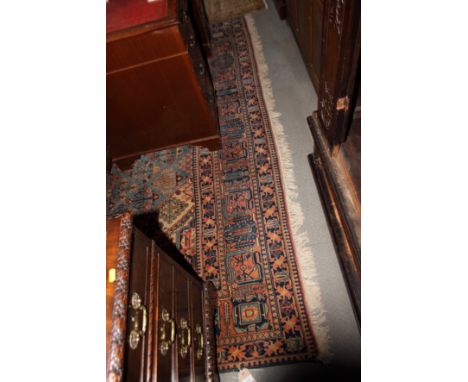 A modern Persian carpet decorated stylised bushes and flowers and stepped central medallion on a blue ground with seven borde