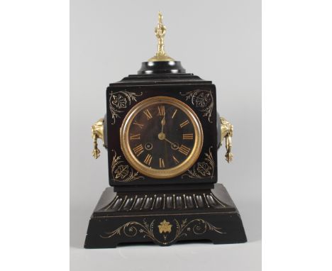 A 19th Century mantel clock in black slate case with gilt decoration, gilt metal finial and lion mask side handles, 14" high