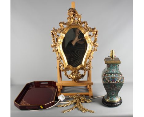 A cloisonne table lamp, a lacquered tray and a carved gesso Rococo style wooden mirror and two brass bows