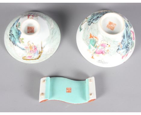 A Chinese polychrome decorated scroll shape brush rest, 3 1/2" long, and a Chinese polychrome decorated bowl and saucer (chip
