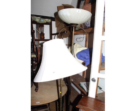 A gilt metal uplighter with white glass shade and a gilt metal standard lamp