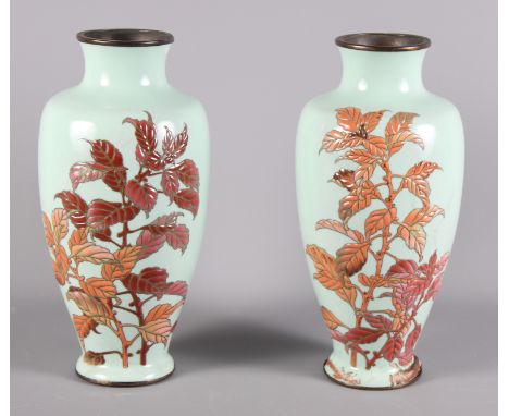 A pair of enamel on copper oviform vases decorated leaves, 11" high (damages), a pair of glass flower vases with silver tops 