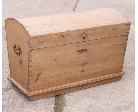 A 19th Century pine trunk with dome top and metal carrying handles, 38" wide
