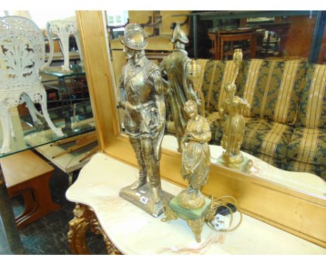 A metal figural lamp on Onyx base and a statue of a Knight in armour