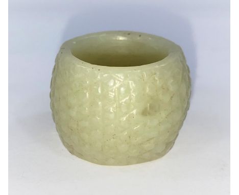 A Chinese Jade coloured hardstone archers ring with textured surface.&nbsp;&nbsp;In good condition.