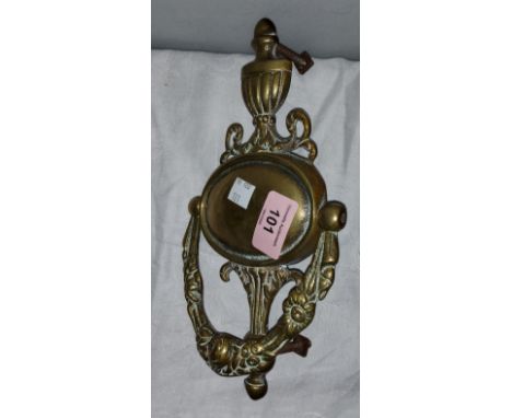 A heavy brass door knocker with classical vase finial 