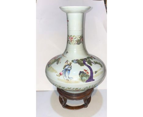 A Chinese ceramic vase with wide squat body and thin neck with flared rim, decorated with characters in robes with trees and 