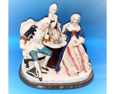 A Dresden style china two bottle ink stand, the cover in the form of figures playing chess, length 72cm. 