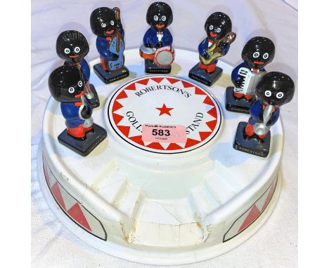 A vintage ceramic Robertson's band stand and 7 piece ceramic band (band stand a.f).&nbsp;&nbsp;The band stand is cracked and 