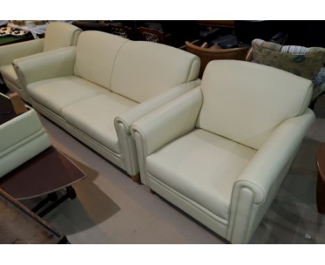 A 4 piece cream leather suite comprising 3 seater settee, pair of armchairs and pouffe -- Armchair with 88cm width, depth 92c