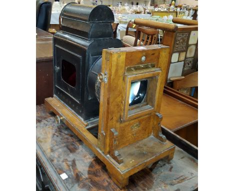 An antique Japaned lantern projector with added wooden Houghtons enlarger. 