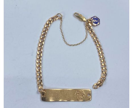 A yellow metal flattened curb link name bracelet with blue enamel fob and safety chain, all stamped 10K (part of chain detach