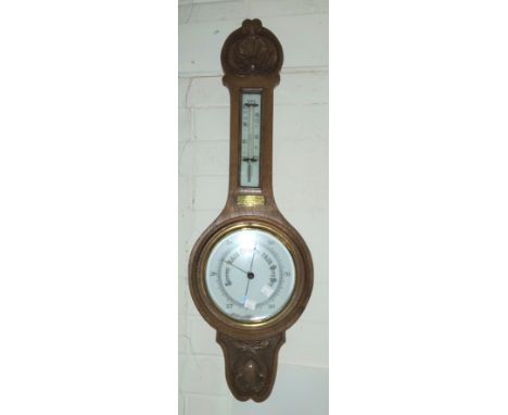 A banjo barometer in oak case; an ash framed mirror, 93 x 53 cm overall 