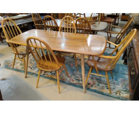 A 1960's Ercol light elm dining suite comprising rounded rectangular table, length 151cm and 4 high hoop and stick back dinin