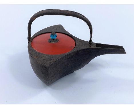 A Japanese gram tetsubin decorated with flowers in relief, red lacquered lid and blue glass finial, length 18cm.&nbsp;&nbsp;G