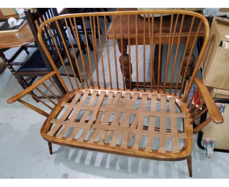 An Ercol two seater stick back settee 