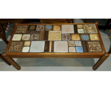 A 1960's teak record cabinet with slate tiles to the front decorated with animals; a 1960's tile top coffee table designed by