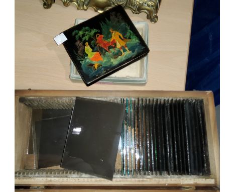 A 20th century Russian box with highly detailed painting of a sledge and driver and a small selection of lantern slides in a 