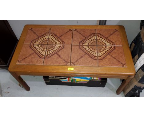 A 1960's teak tile top coffee table