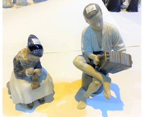 A B &amp; G Copenhagen group, young man on a barrel playing the accordion, height 23cm; a Royal Copenhagen figure of an Amish